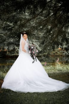 White Bride at her wedding posing with veil