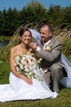 a just married man and woman by a lake
