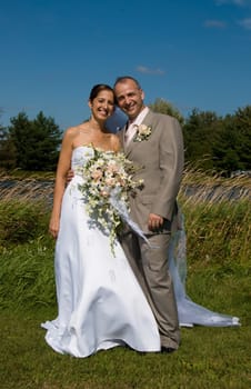 a just married man and woman by a lake