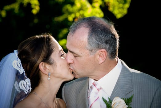 a just married man and woman by some trees