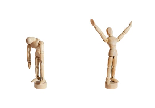 Two wooden mannequins, one celebrating and the other sad, against white background.