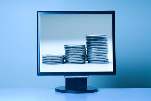 stand alone computer screen on blue with coins on the screen