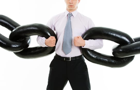 Powerful businessman holding sections of huge chain over white background