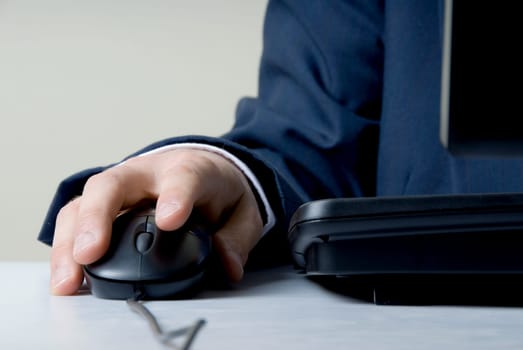 man holding mouse by computer