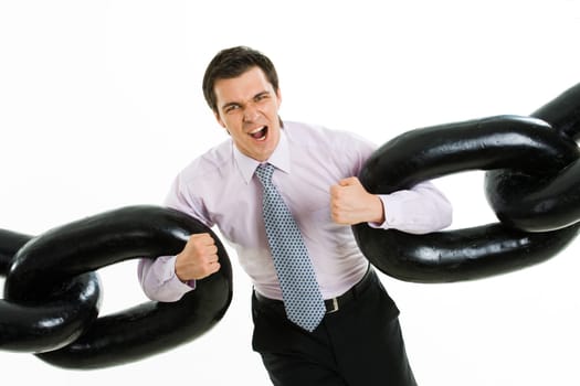 Portrait of frantic businessman with two sections of heavy chain screaming into camera