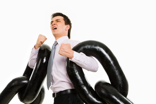 Portrait of tense businessman with two sections of huge chain showing that it is heavy