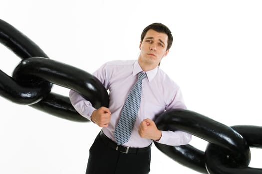 Portrait of helpless businessman holding two sections of huge chain and looking at camera isolated on white background