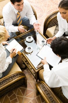 Vertical image of people interacting together at meeting