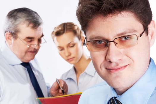 Face of handsome businessman wearing glasses looking at camera