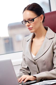 Portrait of a successful businesswoman typing in office