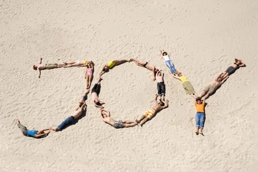 Image of word joy made up of young people resting on the sand