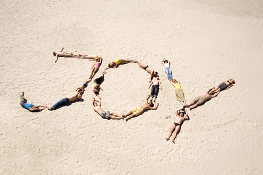 Image of word joy made up of young people resting on the sand