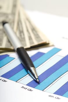 chart with pen and cash on a desk in office