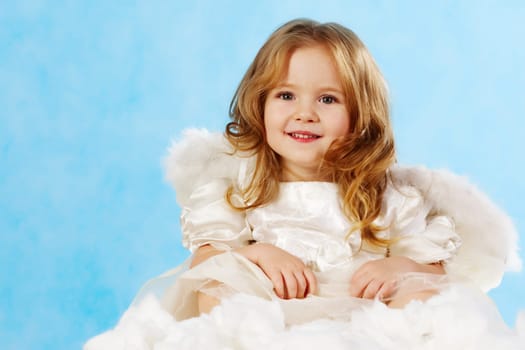 Happy little girl with smile wearing angel dress
