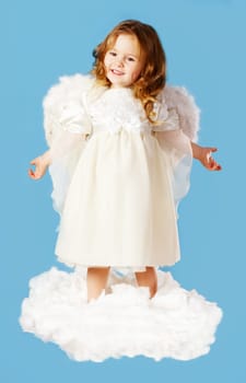 Portrait of cute little cupid standing on cloud