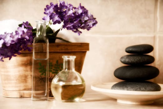 day spa products with stones, oil container, flowers