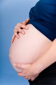 very pregnant woman showing her big belly