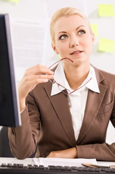 Portrait of pensive businesswoman sitting at workplace