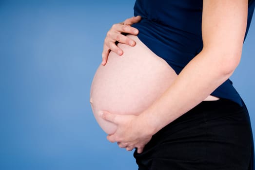 very pregnant woman showing her big belly