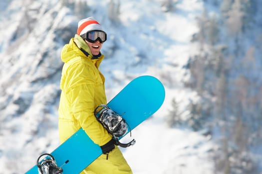 View of sportsman with snowboard standing in the forest