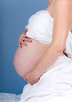 very pregnant woman showing her big belly