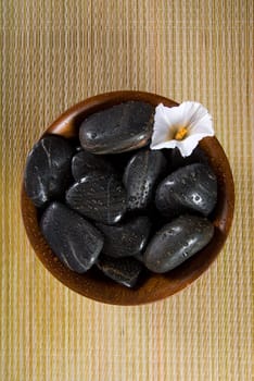spa products with stones in a bowl