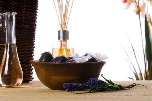 spa products with stones massage flasks and oil