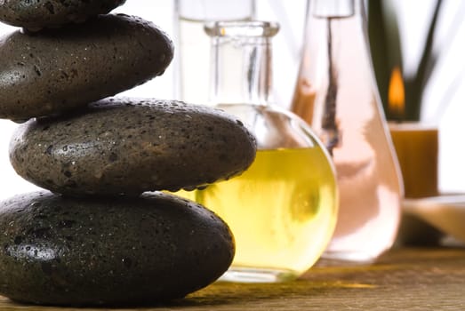 spa products with stones massage flasks and oil