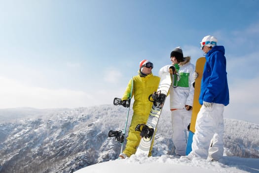 Portrait of handsome snowboarders standing on the mountain