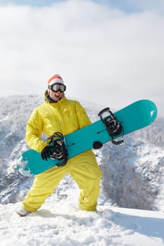 View of sportsman with snowboard standing in the forest