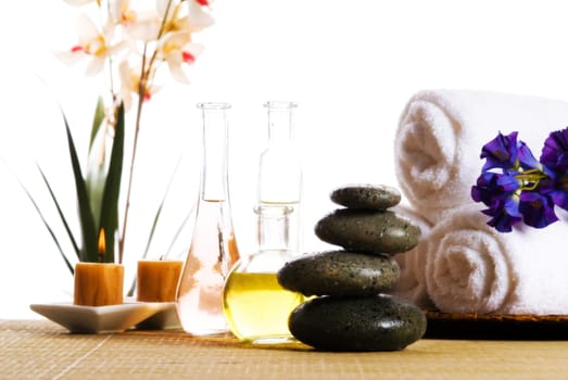spa products with stones towels flasks and oil