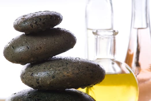 spa products with stones massage flasks and oil