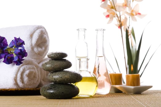 spa products with stones towels flasks and oil