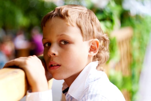 Portrait of handsome schoolboy looking at camera