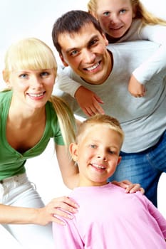 Portrait of happy family in casual clothes looking at camera