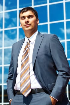 Portrait of confident businessman on background of office building