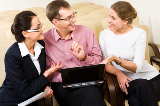 Conversation of three business people at meeting in the conference room