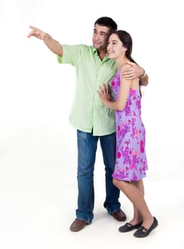 Portrait of young couple looking at something pointed at by man