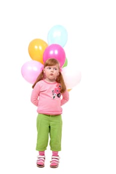 Image of small girl with helium balloons looking aside at party