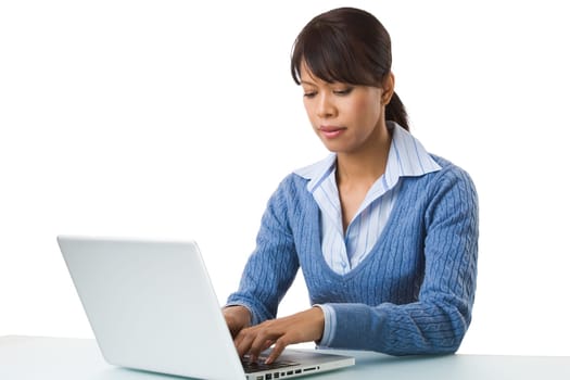 Image of young successful employer typing on laptop at workplace