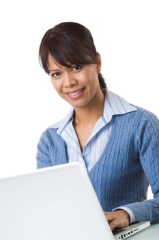 Image of young successful employer typing on laptop and smiling at camera