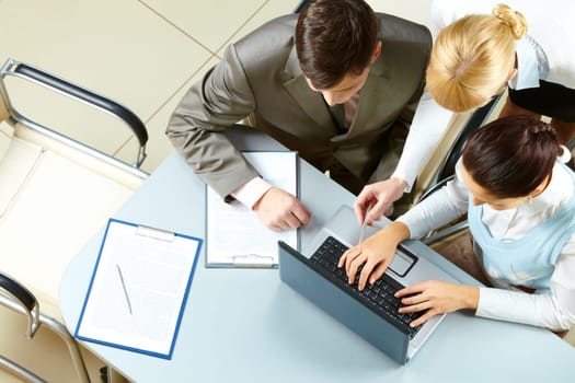 Above view of several business partners interacting at meeting