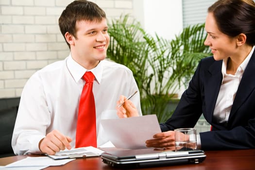Portrait of business man and woman discussing a new business-plan at meeting