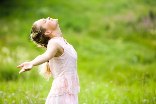 Image of pretty woman with stretched arms and closed eyes enjoying fine weather at leisure