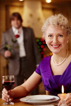 Moment before meeting: woman waiting her man in the restaurant