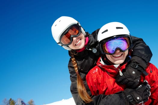 Portrait of happy couple of snowboarders outside during winter vacations