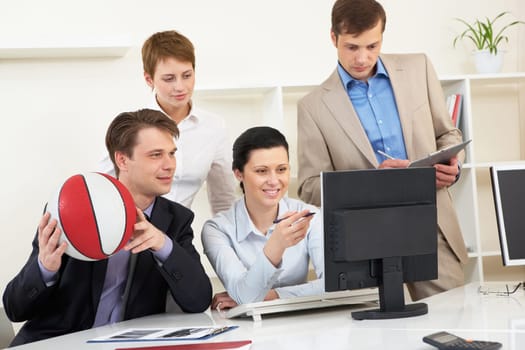 Portrait of business people looking at screen of computer in office