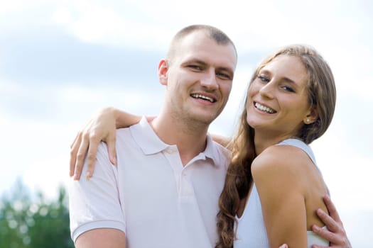 Smiling female and her husband embracing each other