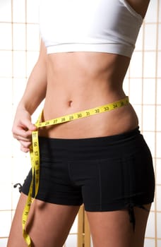 Woman with a tape measure at the waist
