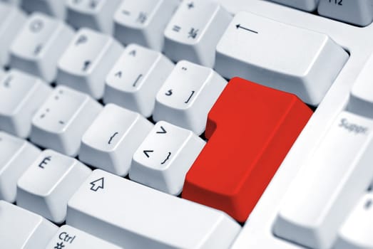 computer keyboard with a blank red button